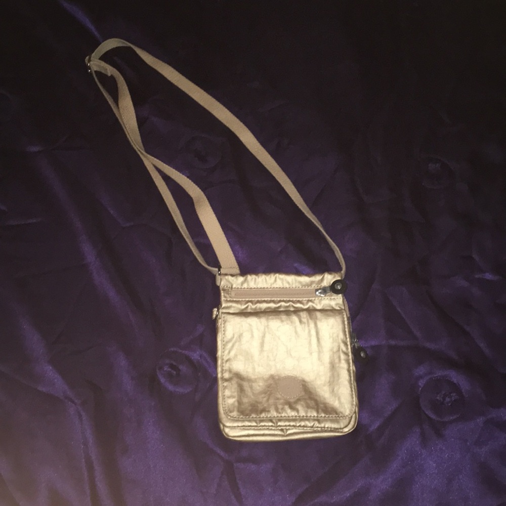 Gold Kipling sling purse